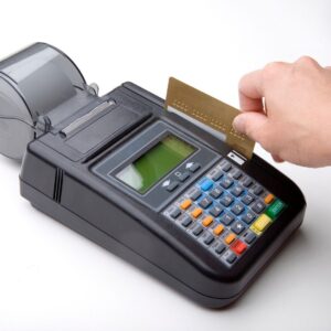 Person swiping credit card into credit card machine