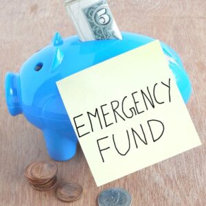 Blue piggy bank with sticky note that reads "emergency fund"