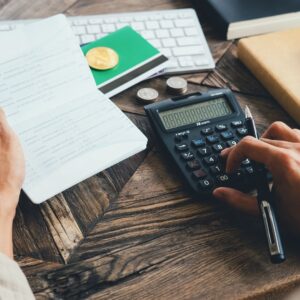 calculator, paper, and bills