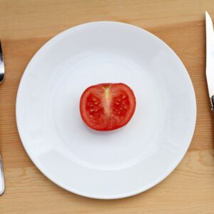 One small tomato on a plate