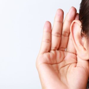 Person cupping their ear to listen better