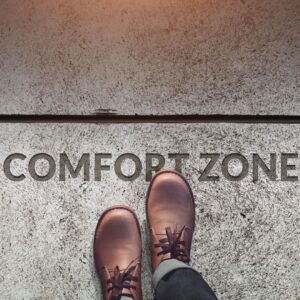 Shoes stepping near line that reads "comfort zone"