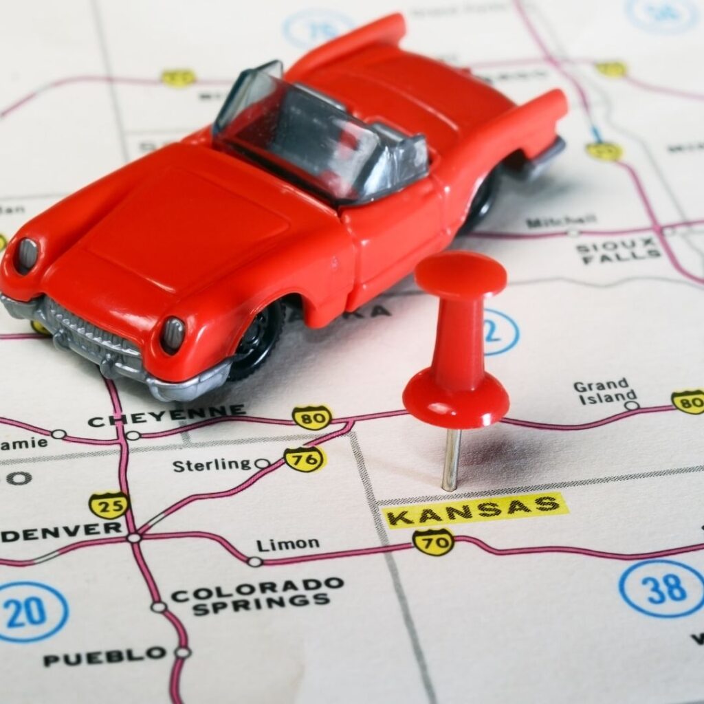 Toy car on map with pin next to it