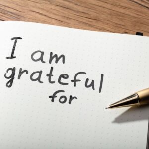 Pen and paper with the words "I am grateful for"