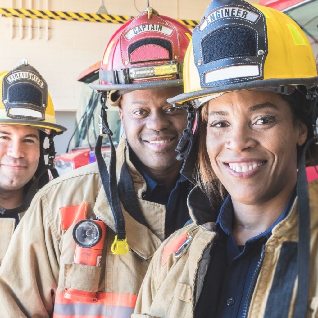 Three firefighters smiling 