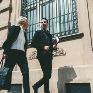 Two men walking in city 