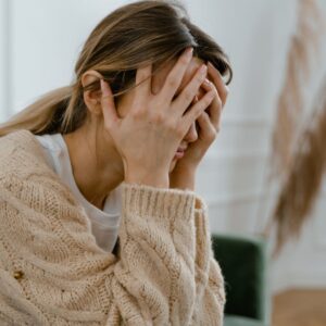 Woman with hands over face